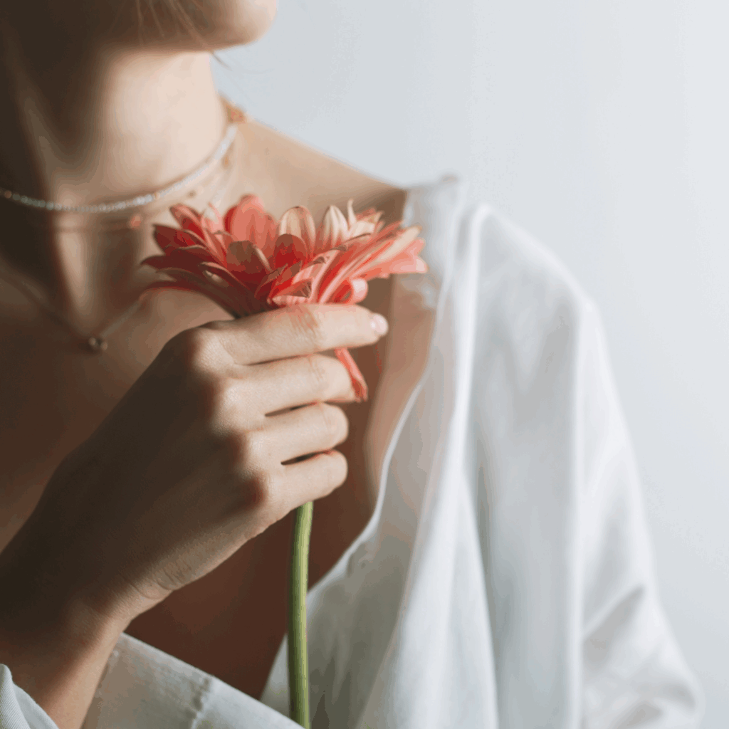 low estrogen symptoms girl holding flower women's health